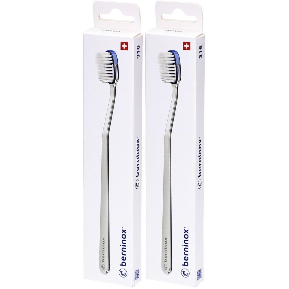 Deux brosses à dents dans des emballages blancs. Les brosses ont des manches argentés et des soies bleues. "berninox" est écrit sur l'emballage.