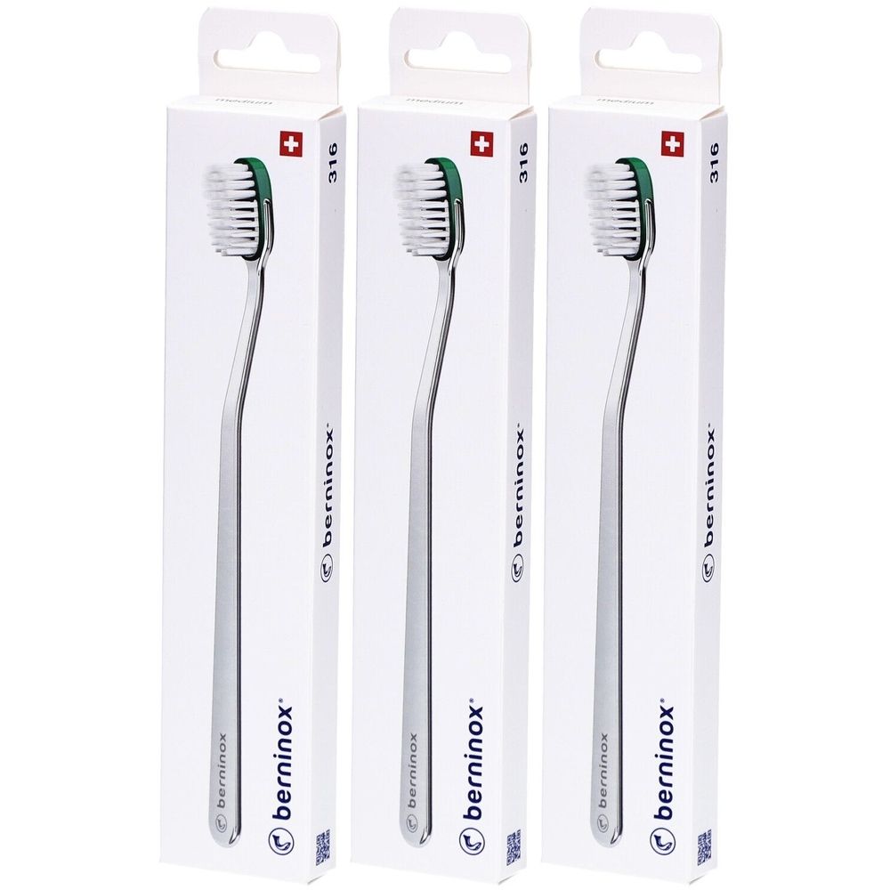 Trois brosses à dents dans des emballages blancs. Les brosses ont un manche argenté et une tête verte. Le nom "berninox" est visible.