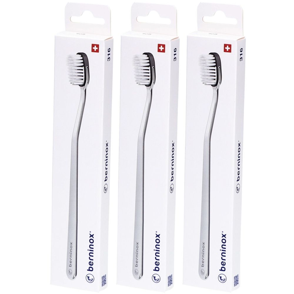 Trois brosses à dents dans des emballages blancs. On distingue des manches argentés, des têtes noires et le logo "berninox".