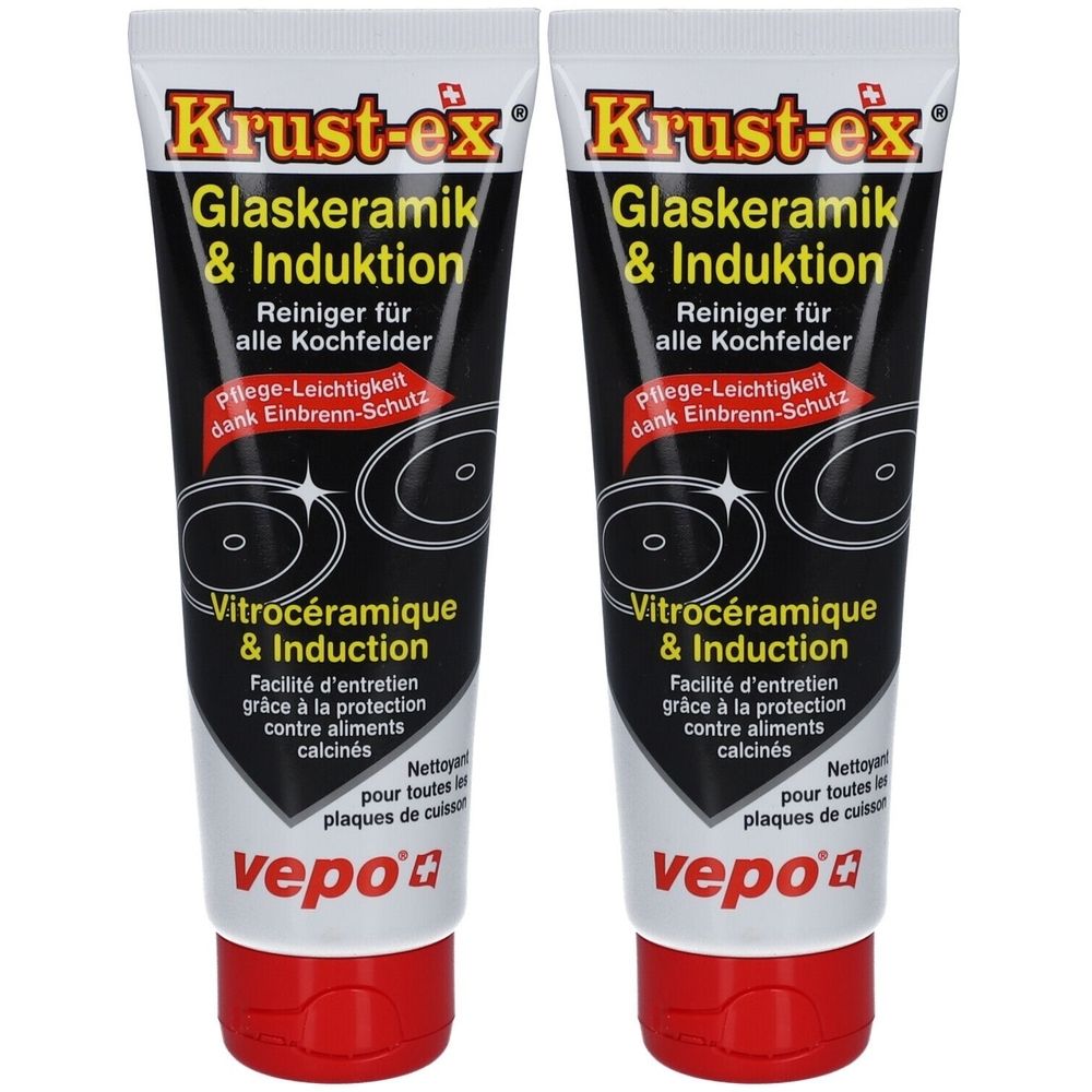 Deux tubes de nettoyant Krust-ex pour vitrocéramique et induction. Tubes blancs avec texte noir et bouchon rouge. Croix suisse.