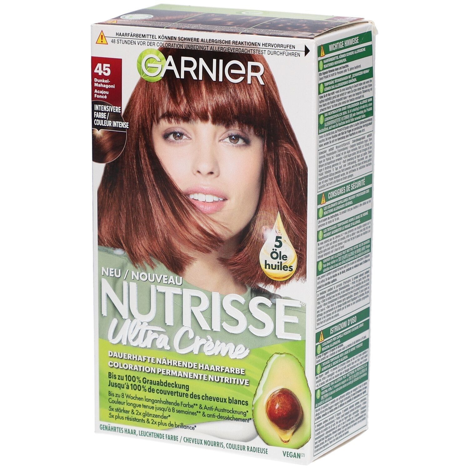 Boîte de coloration capillaire avec femme. Marque GARNIER, produit NUTRISSE Ultra Crème. Teinte 45 acajou foncé. Contient 5 huiles. Vegan.