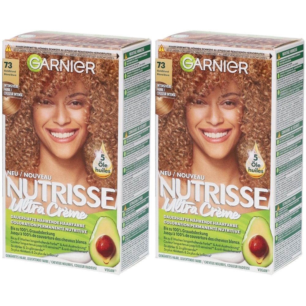 Deux boîtes de coloration capillaire Garnier Nutrisse. Inscription : 73 Blond doré. Illustration d'une femme aux cheveux bouclés. Avocat.