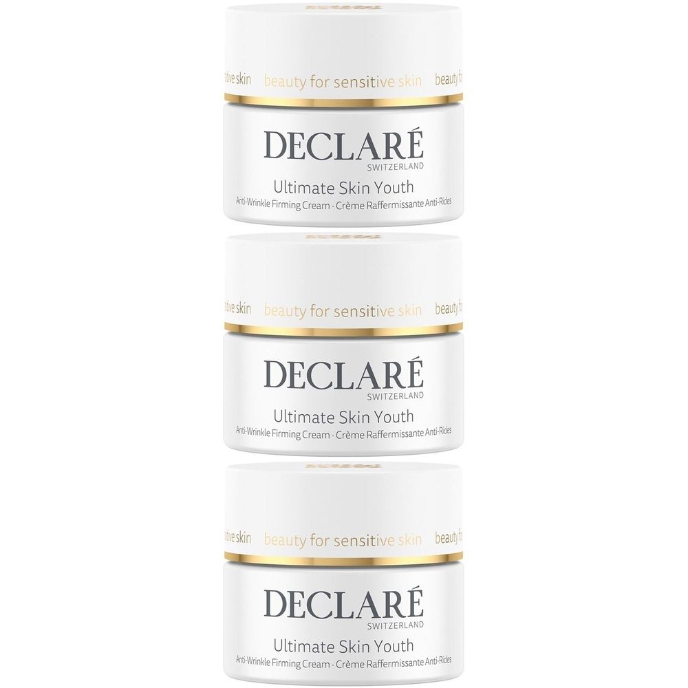 Trois pots blancs avec bord doré. Inscription: DECLARÉ, Ultimate Skin Youth, Anti-Wrinkle Firming Cream.