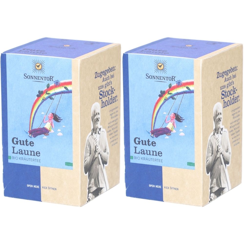 Zwei Kartons SONNENTOR Kräutertee. Auf blauem Grund, Regenbogen-Illustration. Aufschrift: Gute Laune, Bio Kräutertee. Logo: Sonne.
