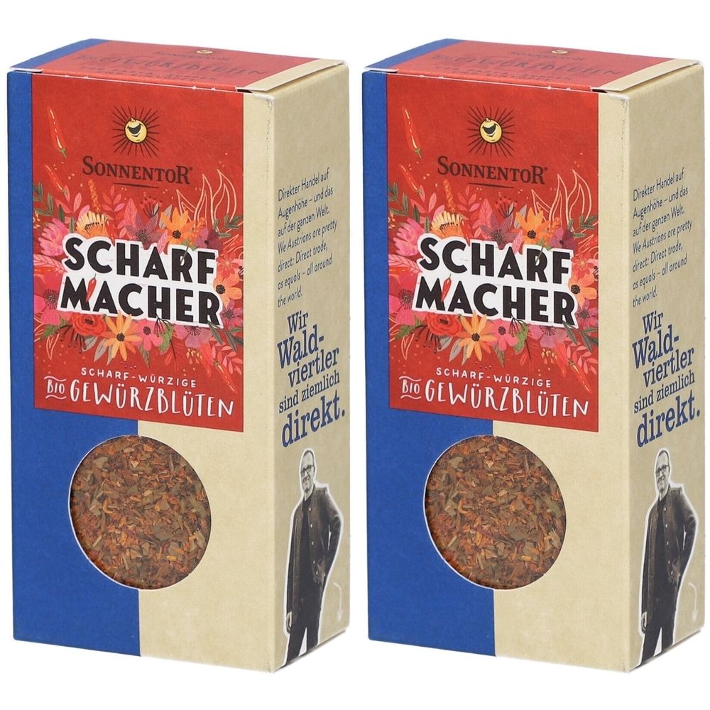 Zwei rechteckige Kartonverpackungen mit "Scharfmacher Gewürzblüten". Roter Deckel mit Logo und floralem Design. Sichtfenster mit Inhalt.