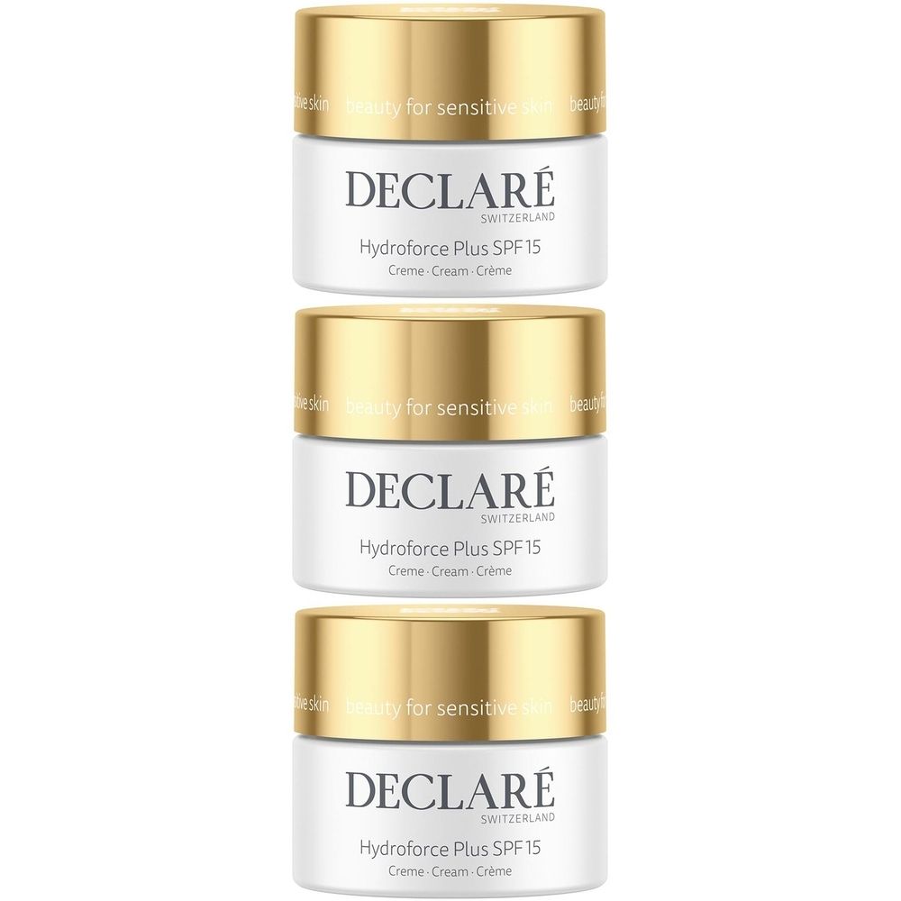 Trois pots de crème avec des couvercles dorés. Sur les pots blancs, on peut lire "DECLARÉ Hydroforce Plus SPF 15".