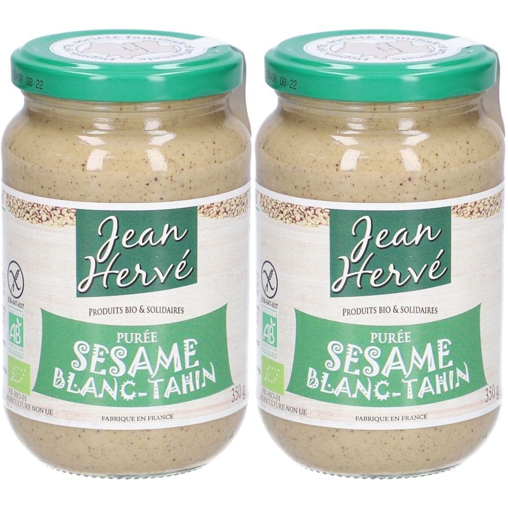 Deux pots de purée de sésame tahini. Couvercle vert, étiquette avec logo et texte. Inscription : Jean Hervé, Purée Sésame Blanc-Tahini, Bio.