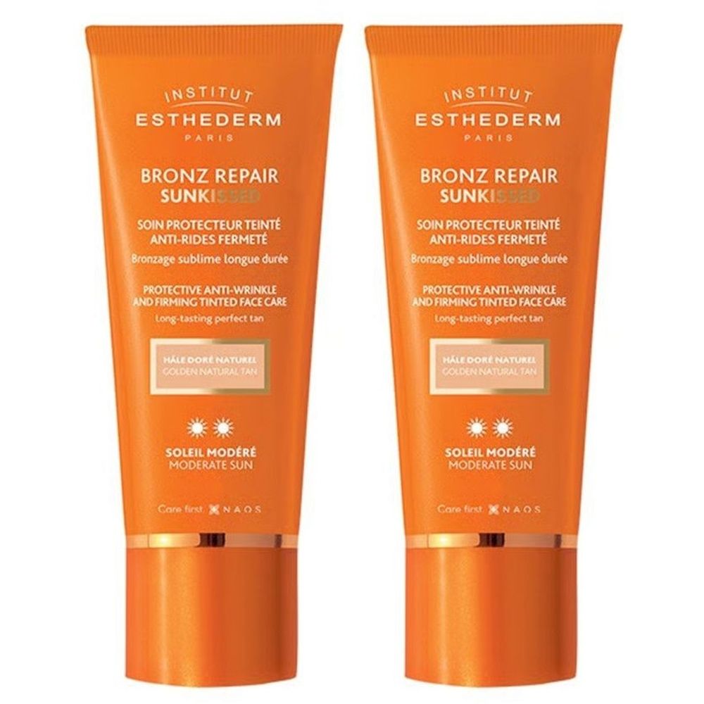 Deux tubes de crème solaire orange. Inscription: Bronz Repair Sunki, Soleil Modéré. Texte blanc. Marque Institut Esthederm.