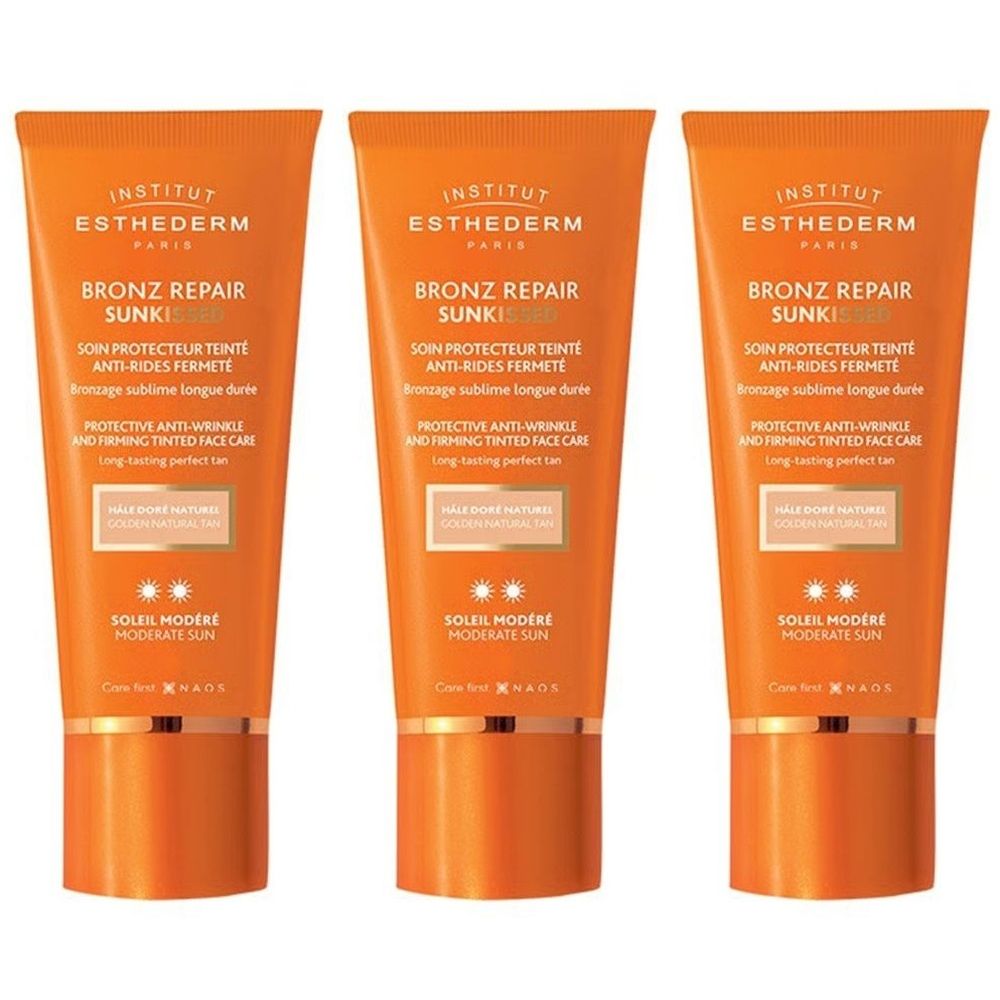 Trois tubes de crème solaire INSTITUT ESTHEDERM Bronz Repair. Tubes orange avec texte blanc. Texte: SOIN PROTECTEUR TEINTE ANTI-RIDES FERMETE.