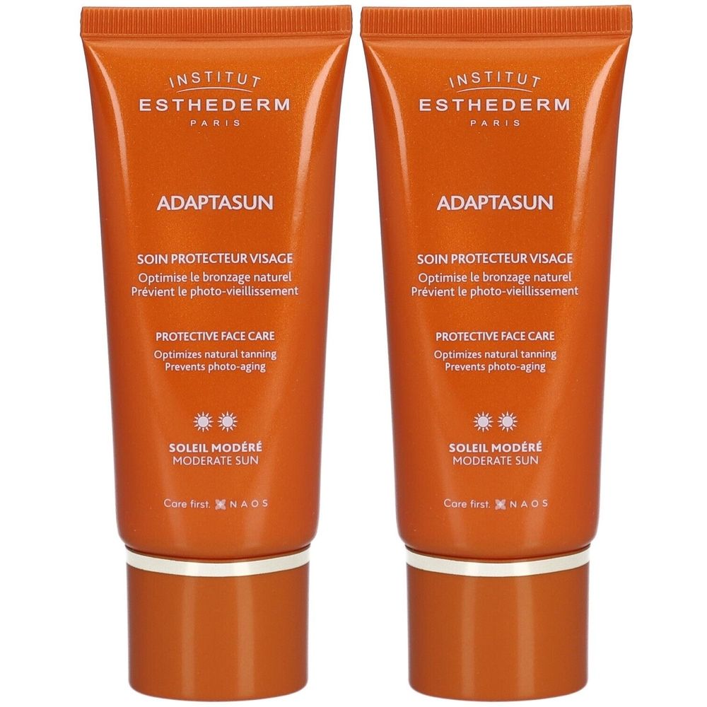 Deux tubes de crème pour le visage orange avec texte blanc. Inscription: INSTITUT ESTHEDERM, ADAPTASUN, SOIN PROTECTEUR VISAGE, SOLEIL MODERE.
