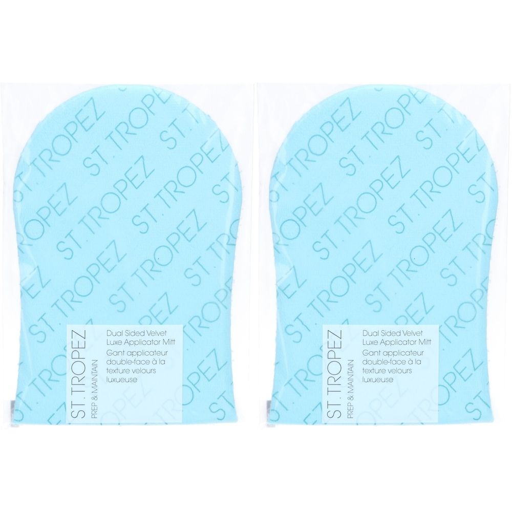 Deux gants applicateurs bleus sous emballage plastique. Inscription : ST. TROPEZ. Texte : Dual Sided Velvet Luxe Applicator Mitt.