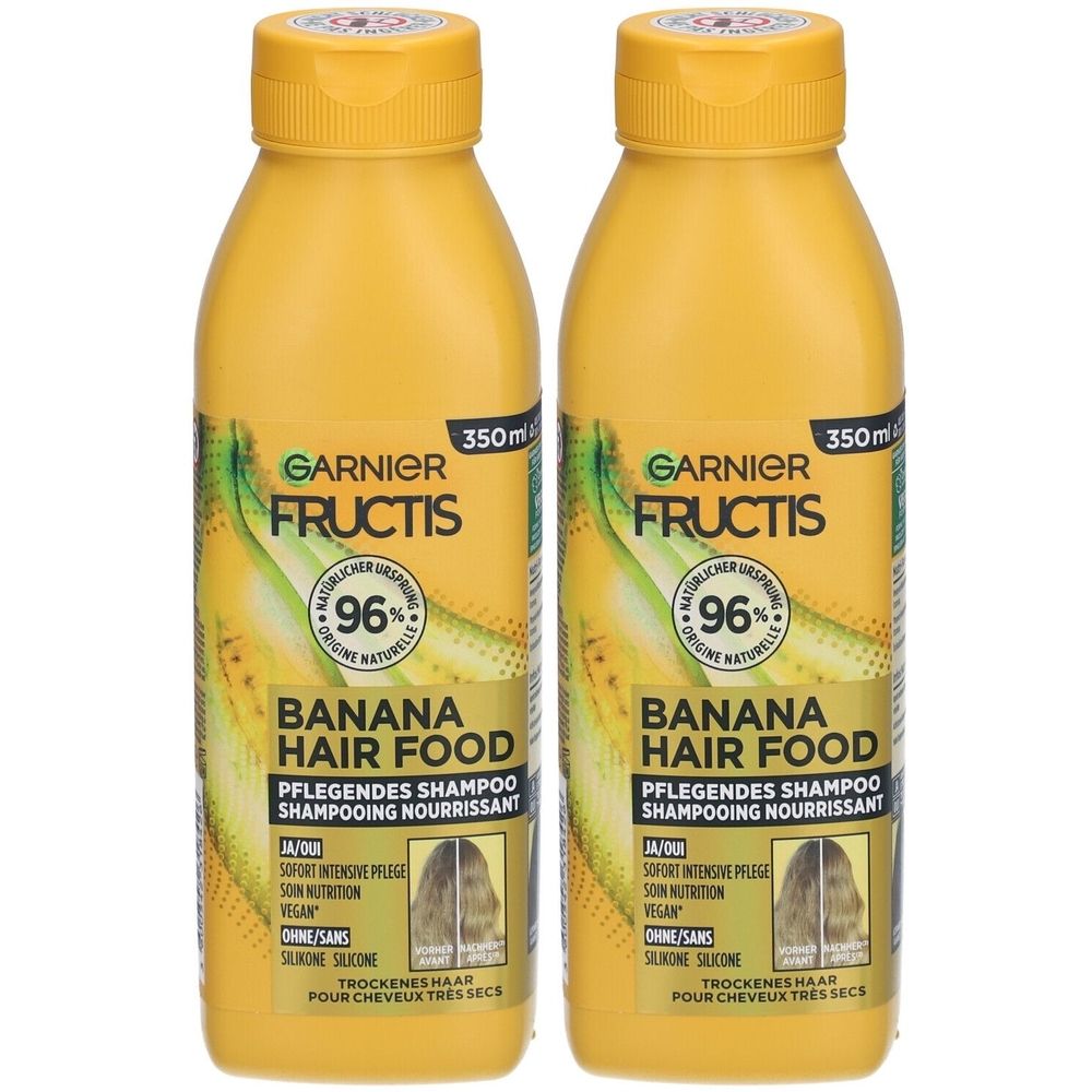 Deux flacons de shampooing jaunes. Inscription: GARNIER FRUCTIS, BANANA HAIR FOOD, 96% d'origine naturelle. 350ml.