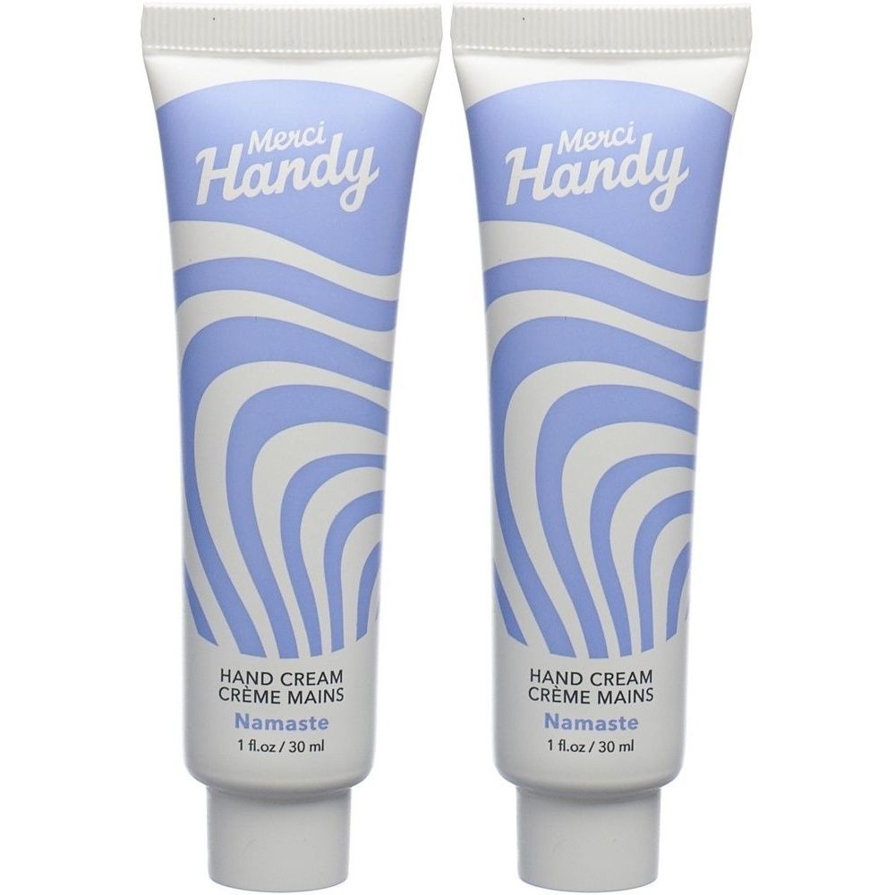 Deux tubes de crème pour les mains. Motifs ondulés bleus et blancs. Inscription : Merci Handy, Hand Cream, Namaste. 1 fl.oz/30 ml.