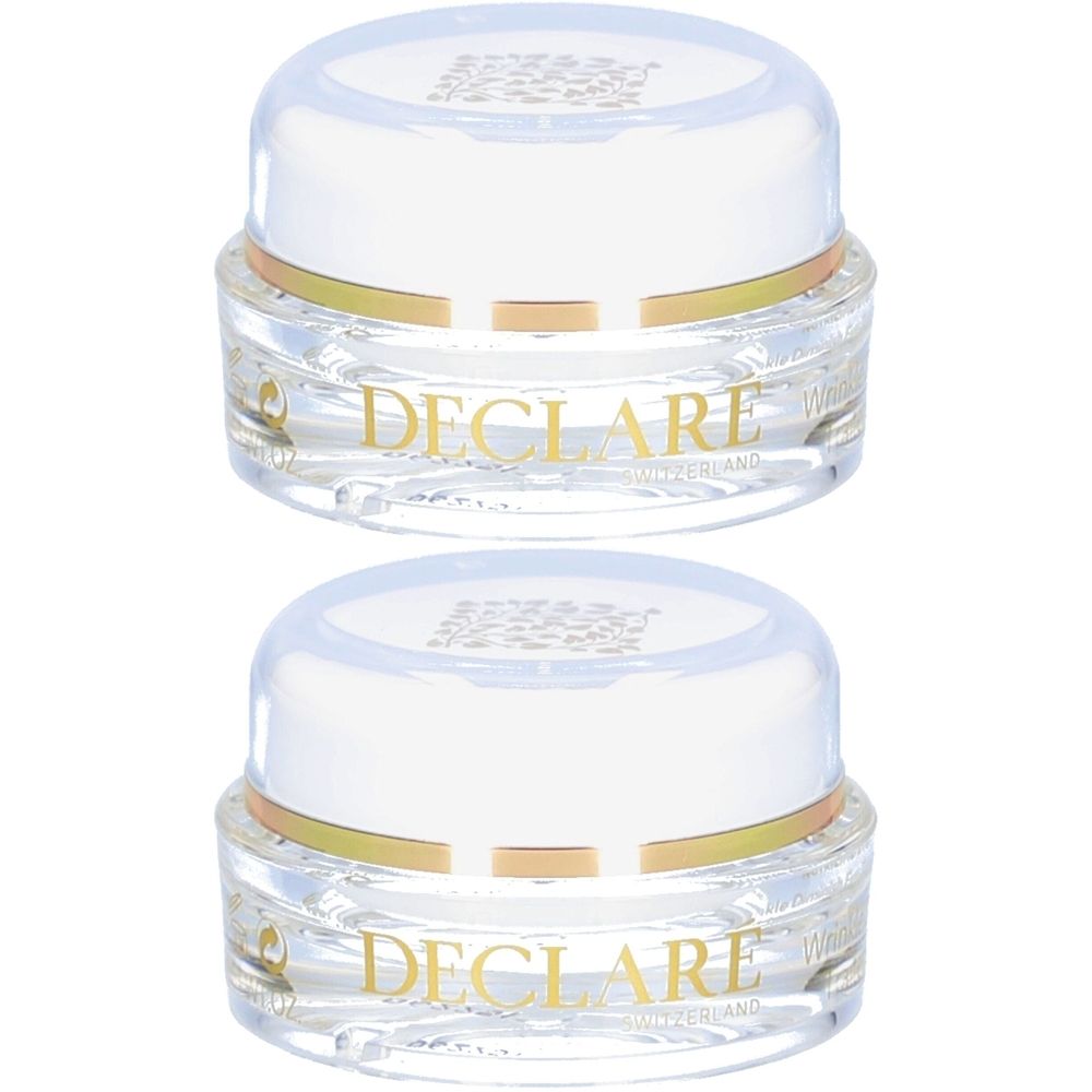 Deux pots transparents avec couvercles blancs. Inscription dorée DECLARE. Inscription: SWITZERLAND. Produit pour le contour des yeux.