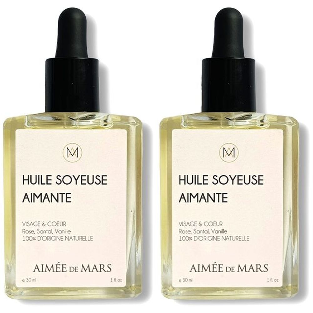 Deux flacons carrés en verre avec compte-gouttes noir. Inscription: Huile Soyeuse Aimante. Marque: Aimée de Mars.