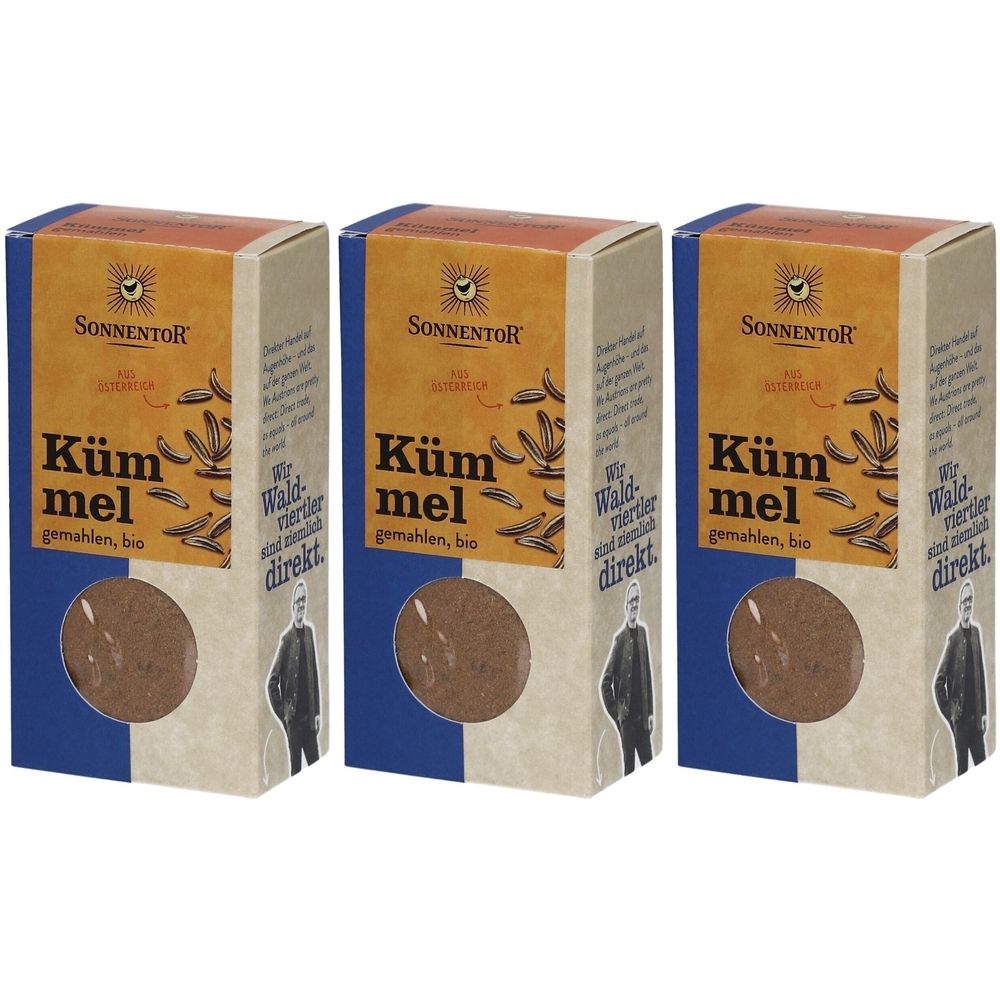 Trois boîtes de SONNENTOR Kümmel gemahlen BIO. Chaque boîte affiche le nom du produit, le logo et du texte. Produit visible à travers une fenêtre ronde.