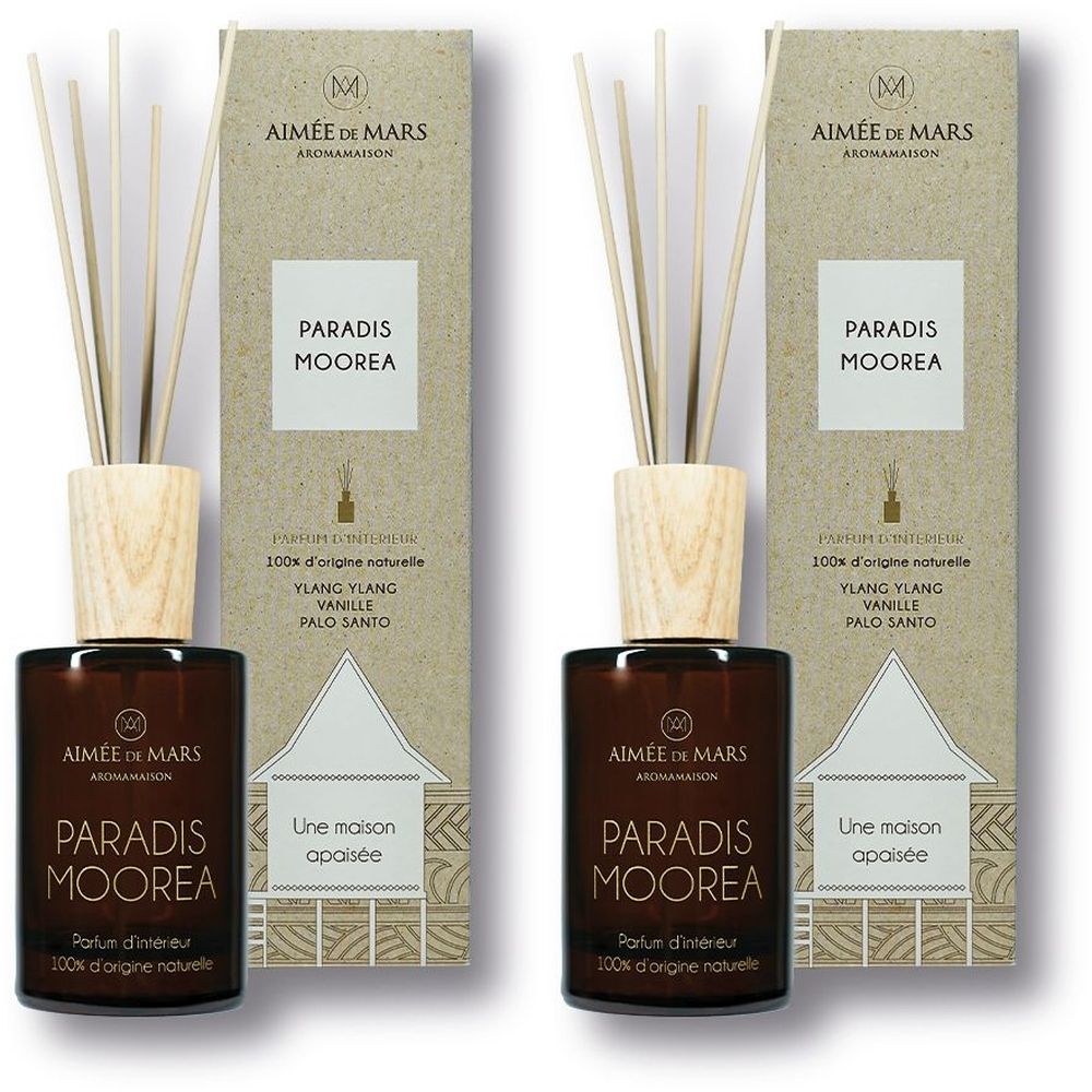 Deux diffuseurs de parfum avec couvercles en bois et bâtonnets. Inscription: Paradis Moorea. Boîte avec logo et texte. 100% ingrédients naturels.
