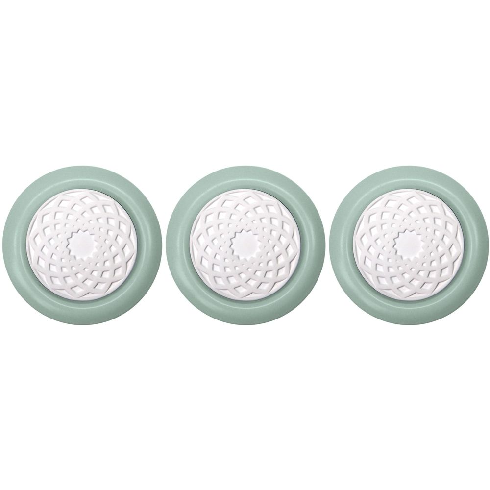 Drei runde, hellgrüne Duftsteine mit weißem, floralem Muster in der Mitte. Die Steine sind nebeneinander angeordnet.