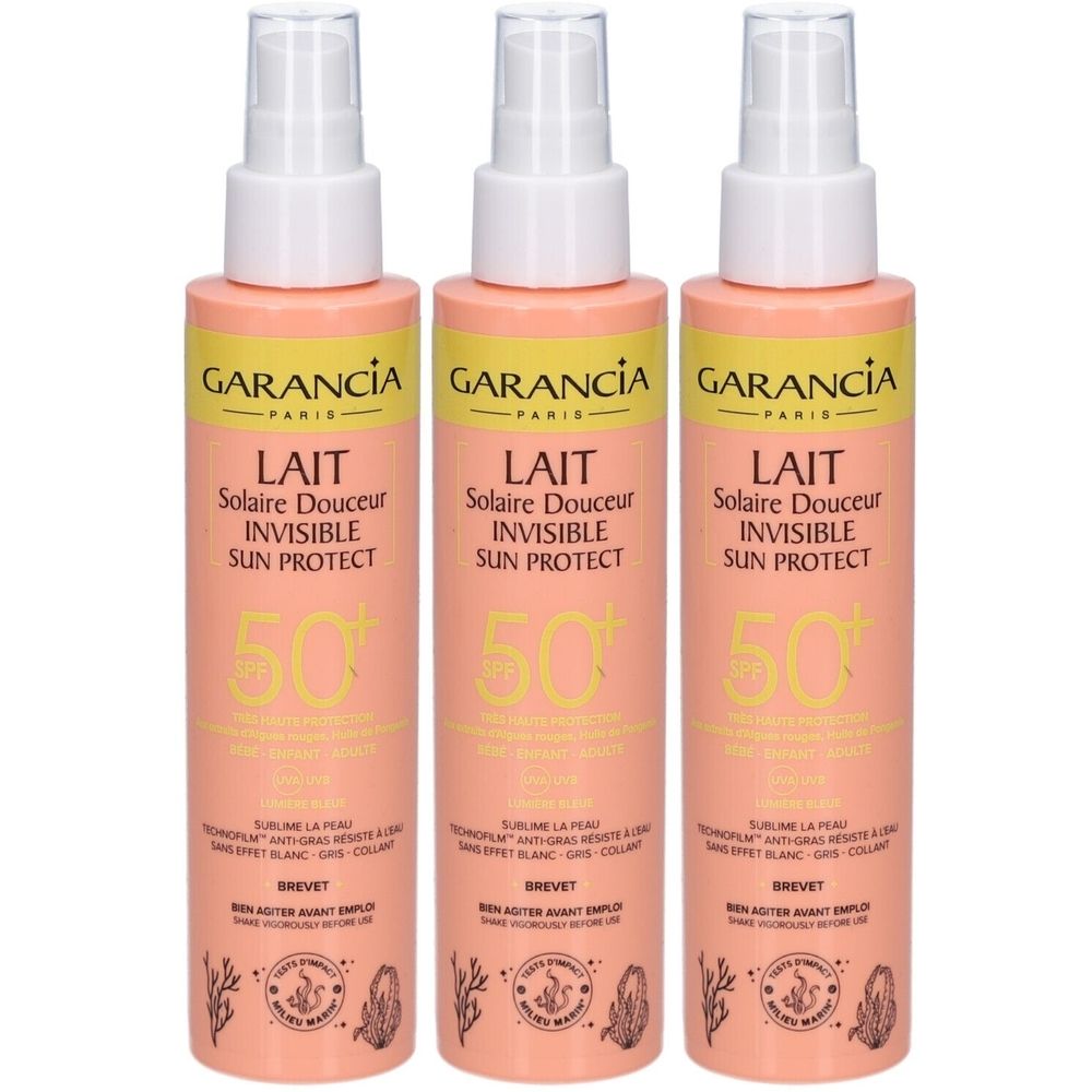 Trois flacons de lait solaire GARANCIA SPF50+. Flacons roses avec vaporisateur blanc. Texte: LAIT Solaire Douceur INVISIBLE SUN PROTECT.