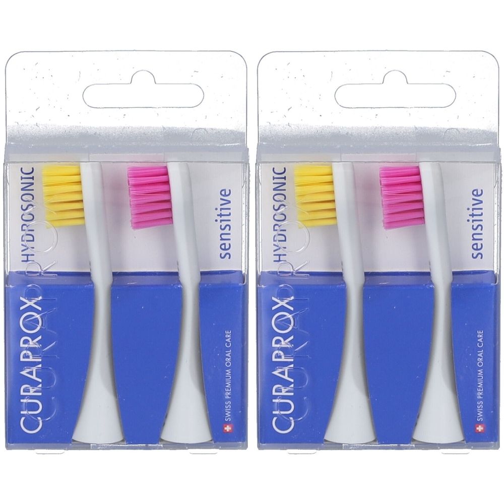 Zwei Packungen Zahnbürstenköpfe. Blaue Verpackung mit weißem und farbigem Bürstenkopf. Schriftzug: CURAPROX, HYDROSONIC, sensitive.
