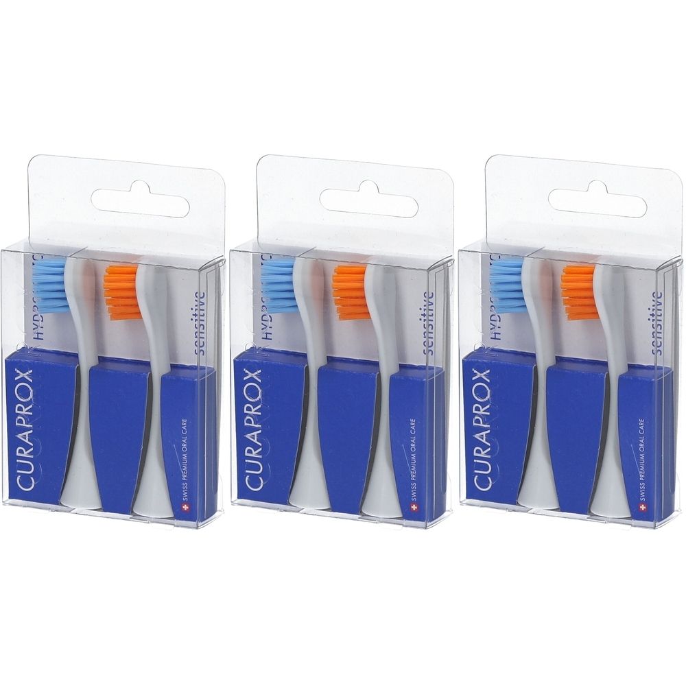 Drei Packungen mit je zwei blauen und weißen Bürstenköpfen. Blaue Borsten, orangefarbene Borsten. Klare Kunststoffverpackung.