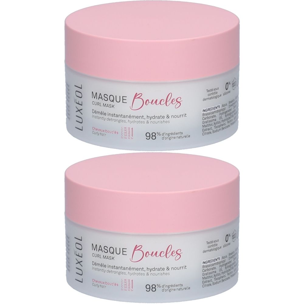Zwei runde Tiegel mit rosa Deckel. Aufschrift: LUXÉOL, Masque Boucles. Text: Entwirrt, hydratisiert & nährt. 98% Inhaltsstoffe natürlichen Ursprungs.