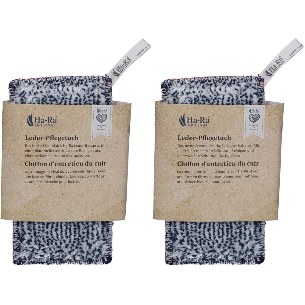 Zwei Leder-Pflegetücher in Verpackung. Die Tücher haben eine schwarz-weiße Musterung. Auf der Verpackung steht "Ha-Ra Original".