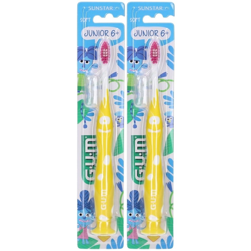Zwei Zahnbürsten in Verpackung. Gelbe Griffe mit weißen Punkten, rote Borsten. Aufschrift: GUM, Junior 6+.