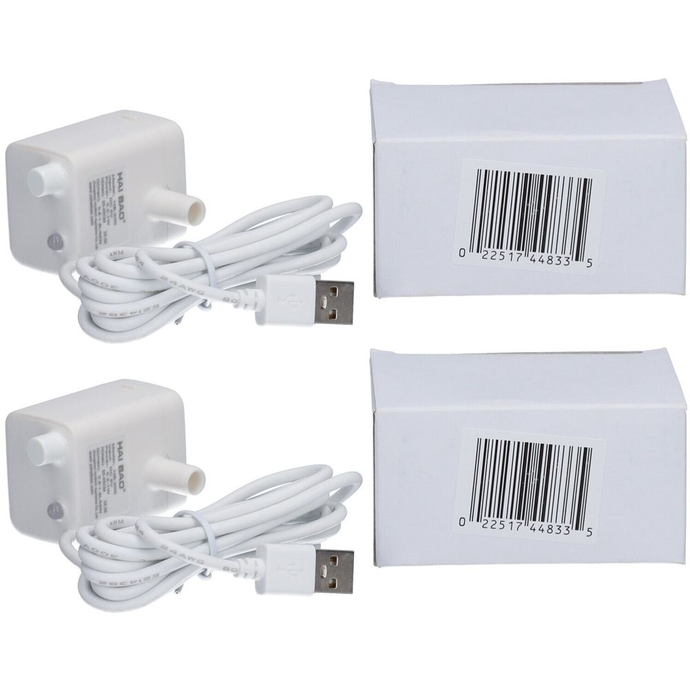 Zwei weiße Pumpen mit Kabeln und USB-Anschlüssen, neben zwei weißen Kartons mit Barcodes.