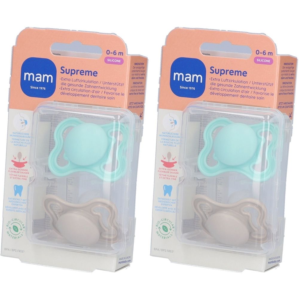 Zwei MAM Supreme Silikon-Schnuller in Verpackung. Hellblauer und beiger Sauger. Altersempfehlung: 0-6 Monate.