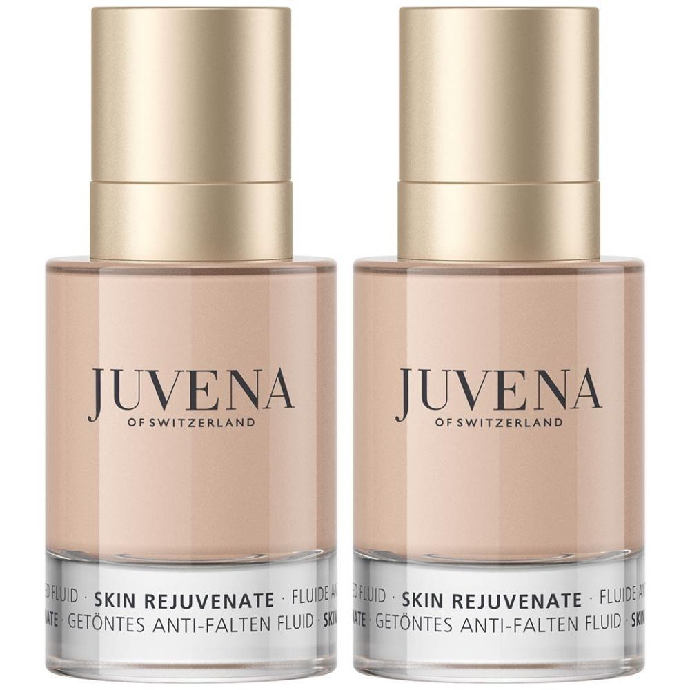 Zwei Flakons mit goldfarbenen Deckeln. Aufschrift: JUVENA OF SWITZERLAND. Darunter: SKIN REJUVENATE FLUIDE. Getöntes Anti-Falten Fluid.