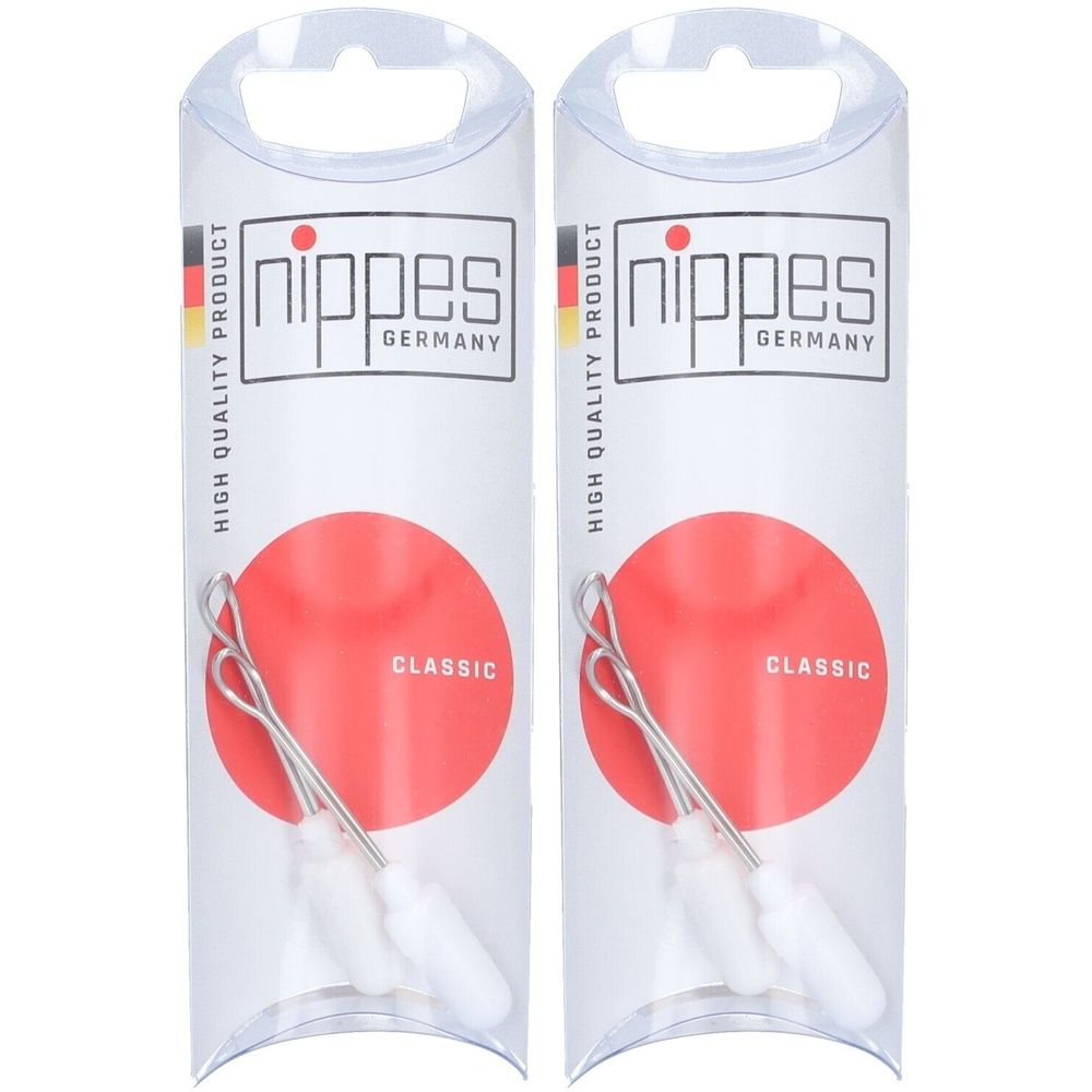 Deux emballages. Chaque emballage contient un ensemble de nettoyage des oreilles. Visible : tige métallique, tête blanche, fond rouge. Marque : nippes GERMANY.