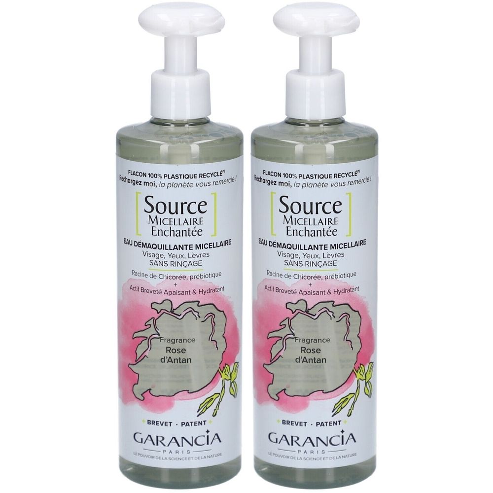 Zwei Flaschen Garancia Eau Micellaire Enchantée. Weiße Pumpaufsätze, transparente Flüssigkeit. Rosa Etikett mit Text und Logo.