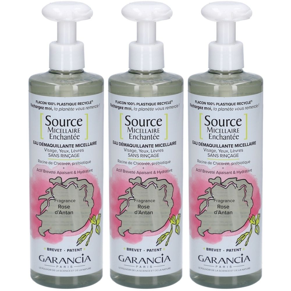 Drei Flaschen Garancia Eau Micellaire Enchantée. Weiße Pumpköpfe. Etiketten mit Text und Rose-Illustration. Marke und Produktname sichtbar.