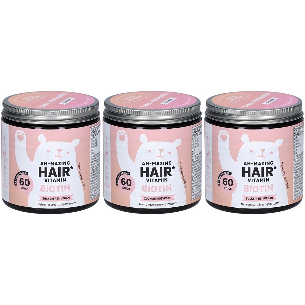 Trois boîtes avec étiquettes roses. Inscription : AH-MAZING HAIR Vitamin Biotin. 60 pièces. Couvercles argentés.