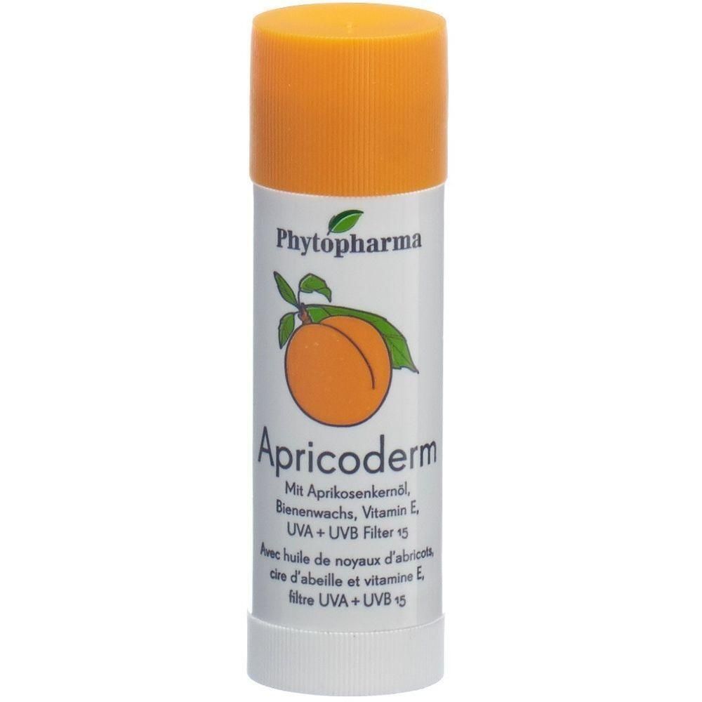 Stick cylindrique avec capuchon orange. Inscription: Phytopharma, Apricoderm, avec huile de noyau d'abricot, filtre UVA + UVB 15. Illustration d'abricot.