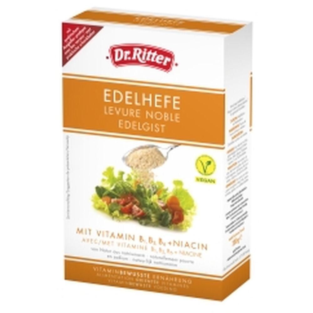 Kartonverpackung von Dr. Ritter Edelhefe. Enthält Vitamin B6, B12 und Niacin. Vegan-Siegel. Abbildung von Salat mit Hefe.