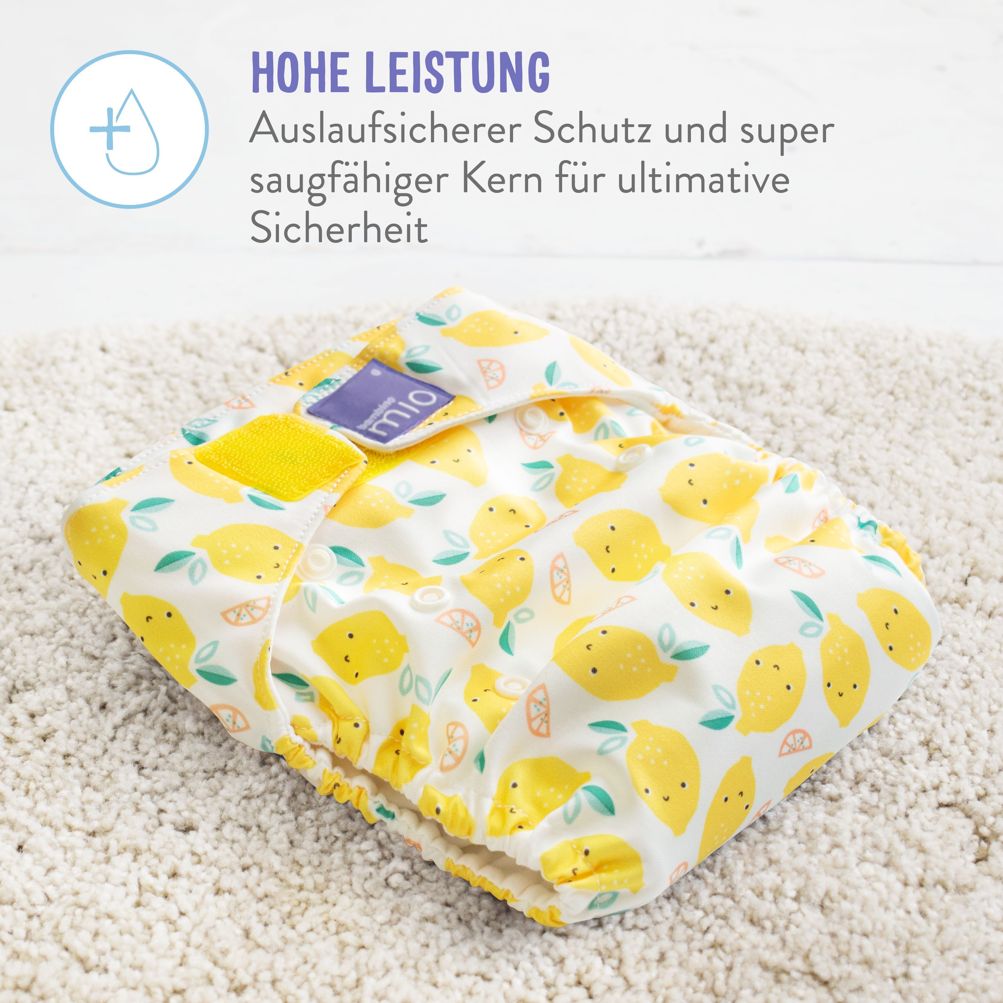 Couche en tissu jaune avec motif citron. Texte : Haute performance, protection anti-fuite et cœur absorbant.