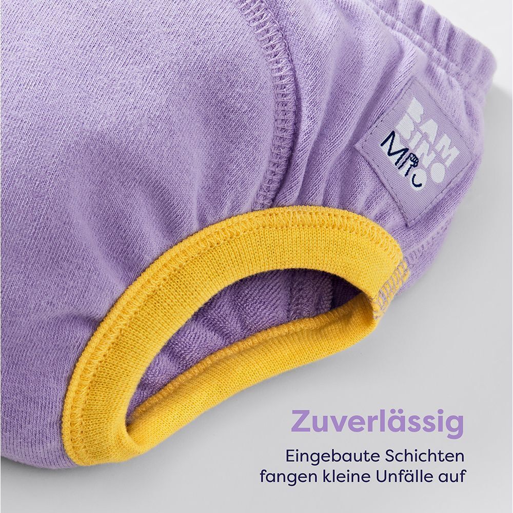 Lila waschbares Lernhöschen. Gelber Bund. Logo-Etikett. Text: Zuverlässig. Eingebaute Schichten fangen kleine Unfälle auf.