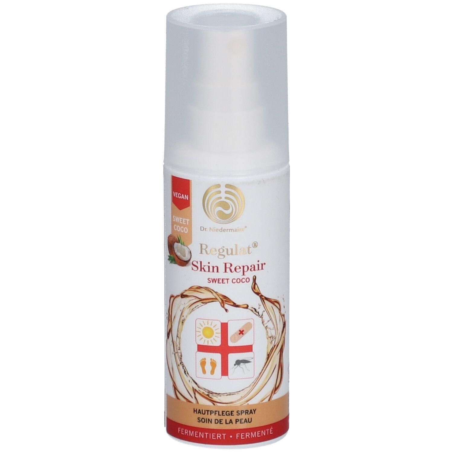 Hautpflegespray mit Sprühkopf. Aufschrift: Regulat Skin Repair, Sweet Coco. Vegan-Siegel. Abbildung: Kokosnuss, Sonne, Pflaster, Fuß, Mücke.