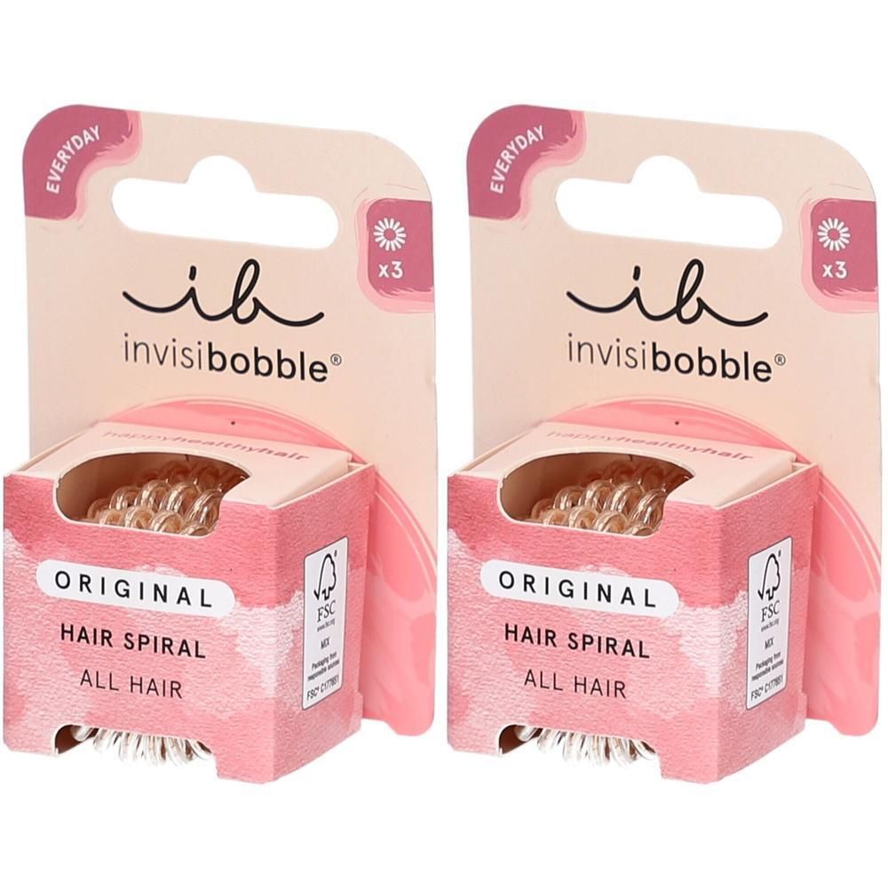 Zwei Invisibobble Original Haargummis im 3er-Pack, transparent, spiralförmig.
