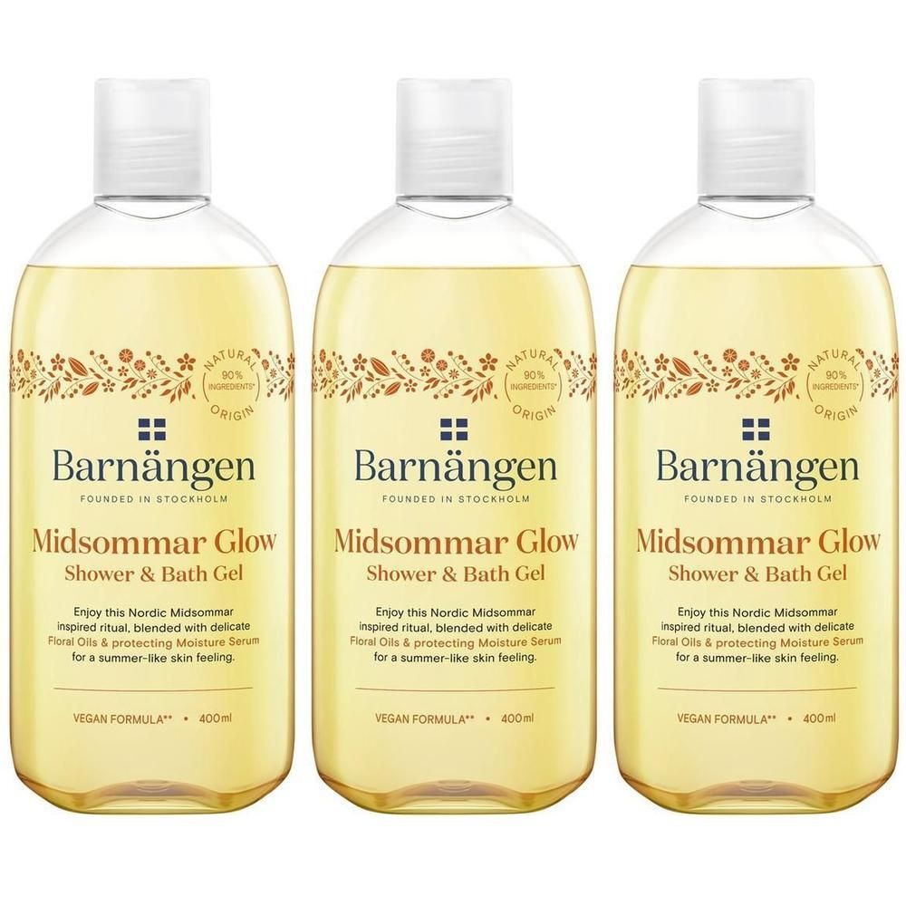 Trois bouteilles de gel douche et bain Barnängen Midsommar Glow avec liquide jaune et motif floral.
