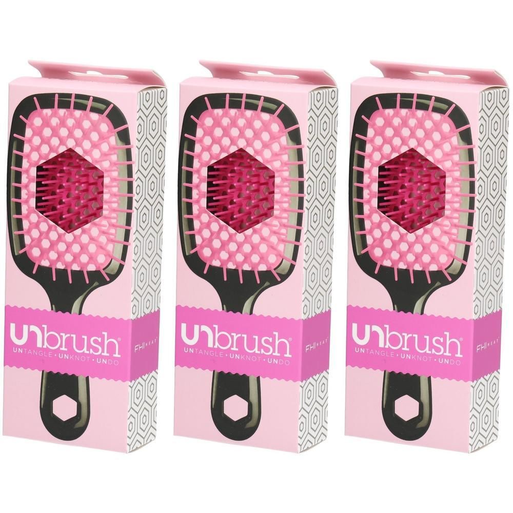 Trois brosses démêlantes Unbrush dans leur emballage rose, avec manche noir et picots roses.