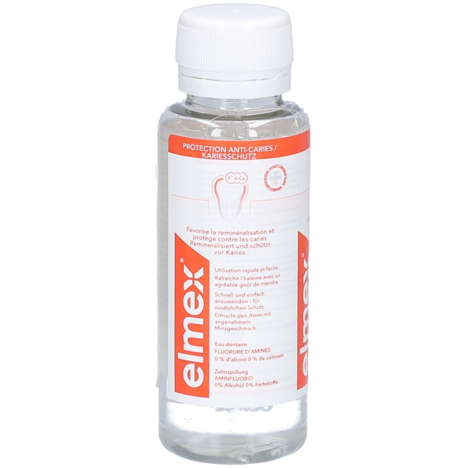 Transparente Flasche mit weißem Deckel. Aufschrift: PROTECTION ANTI-CARIES/KARIESSCHUTZ. Rote und weiße Etiketten mit Produktinformationen.