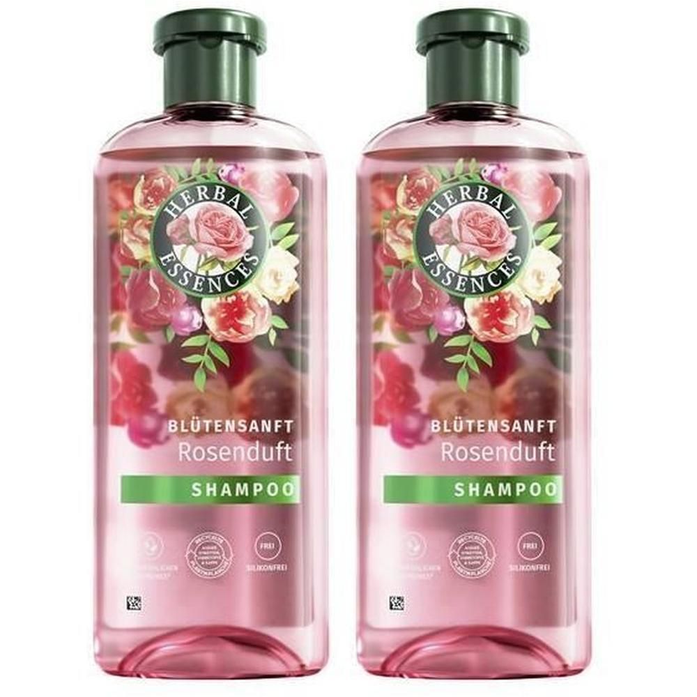 Zwei Flaschen HERBAL ESSENCES Shampoo. Rosa Flüssigkeit, grüner Deckel. Aufschrift: Blütensanft Rosenduft, Shampoo. Mit Blumenmotiv.
