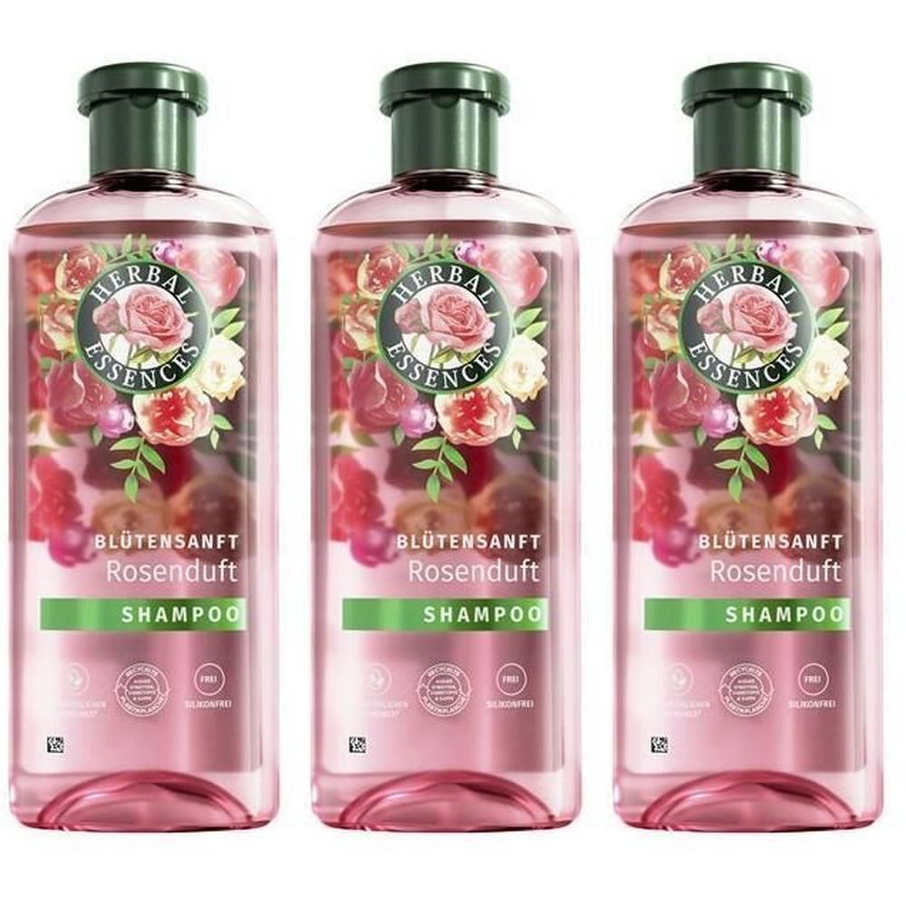 Drei Flaschen Shampoo. Rosa Flüssigkeit, grüner Deckel. Aufschrift: HERBAL ESSENCES, Blütensanft Rosenduft Shampoo.