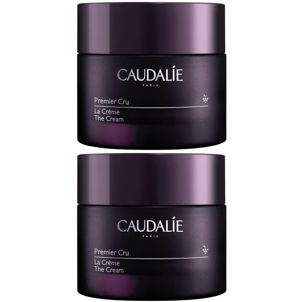 Zwei Tiegel Creme, dunkelviolett. Aufschrift CAUDALIE, Premier Cru, La Crème, The Cream. Mit Traubensymbol.