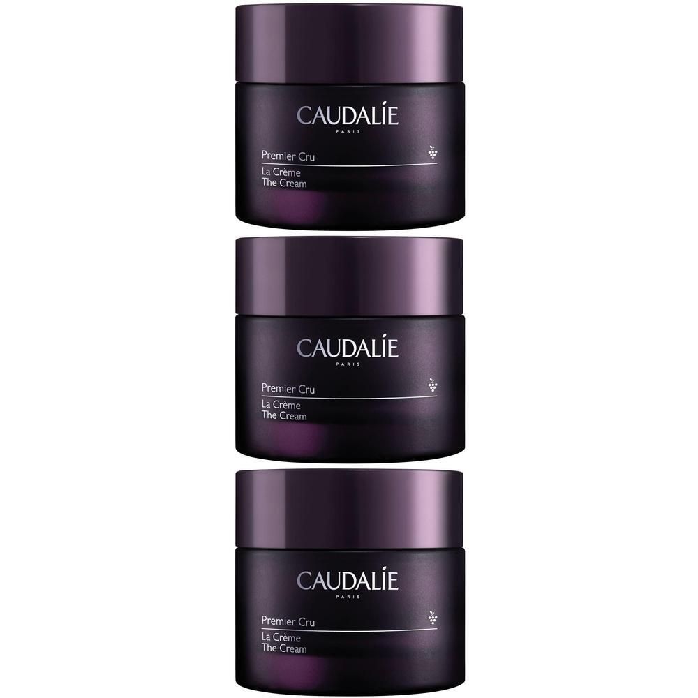 Drei Tiegel Creme, dunkelviolett. Aufschrift CAUDALIE, Premier Cru, La Crème, The Cream. Deckel dunkelviolett.