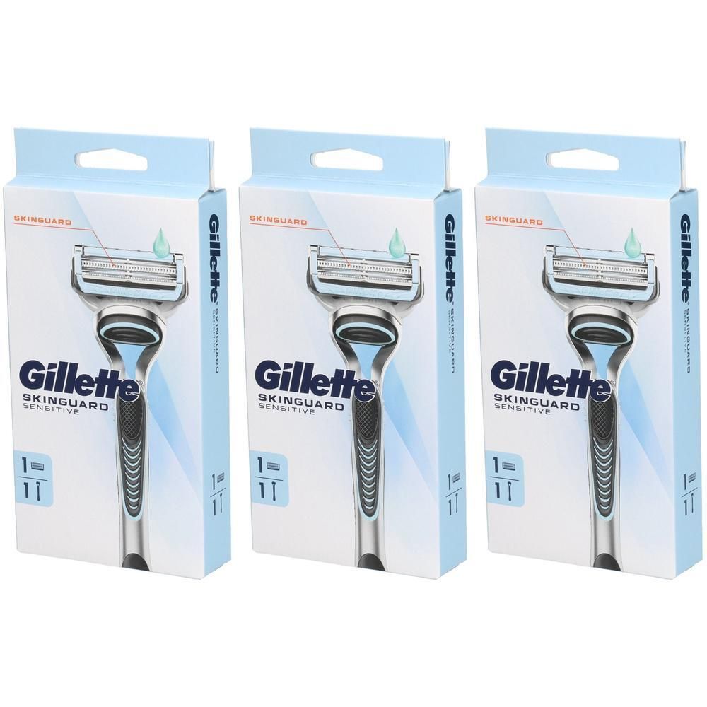 Trois rasoirs dans des emballages. Les emballages affichent la marque Gillette SkinGuard Sensitive. Les rasoirs ont des manches bleus.