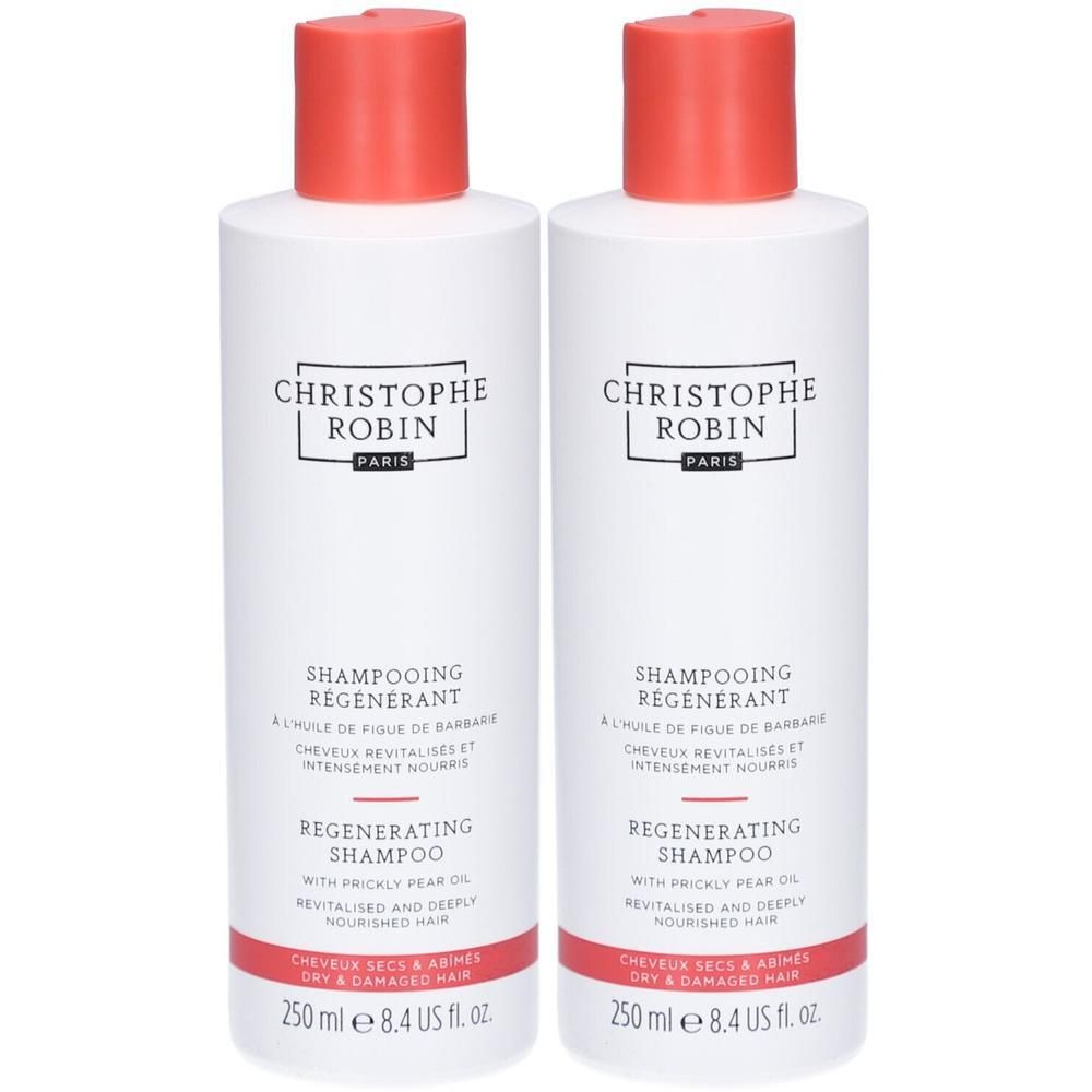 Zwei weiße Flaschen mit rotem Verschluss. Aufschrift: CHRISTOPHE ROBIN PARIS, SHAMPOOING REGENERANT, REGENERATING SHAMPOO. Für trockenes und geschädigtes Haar.